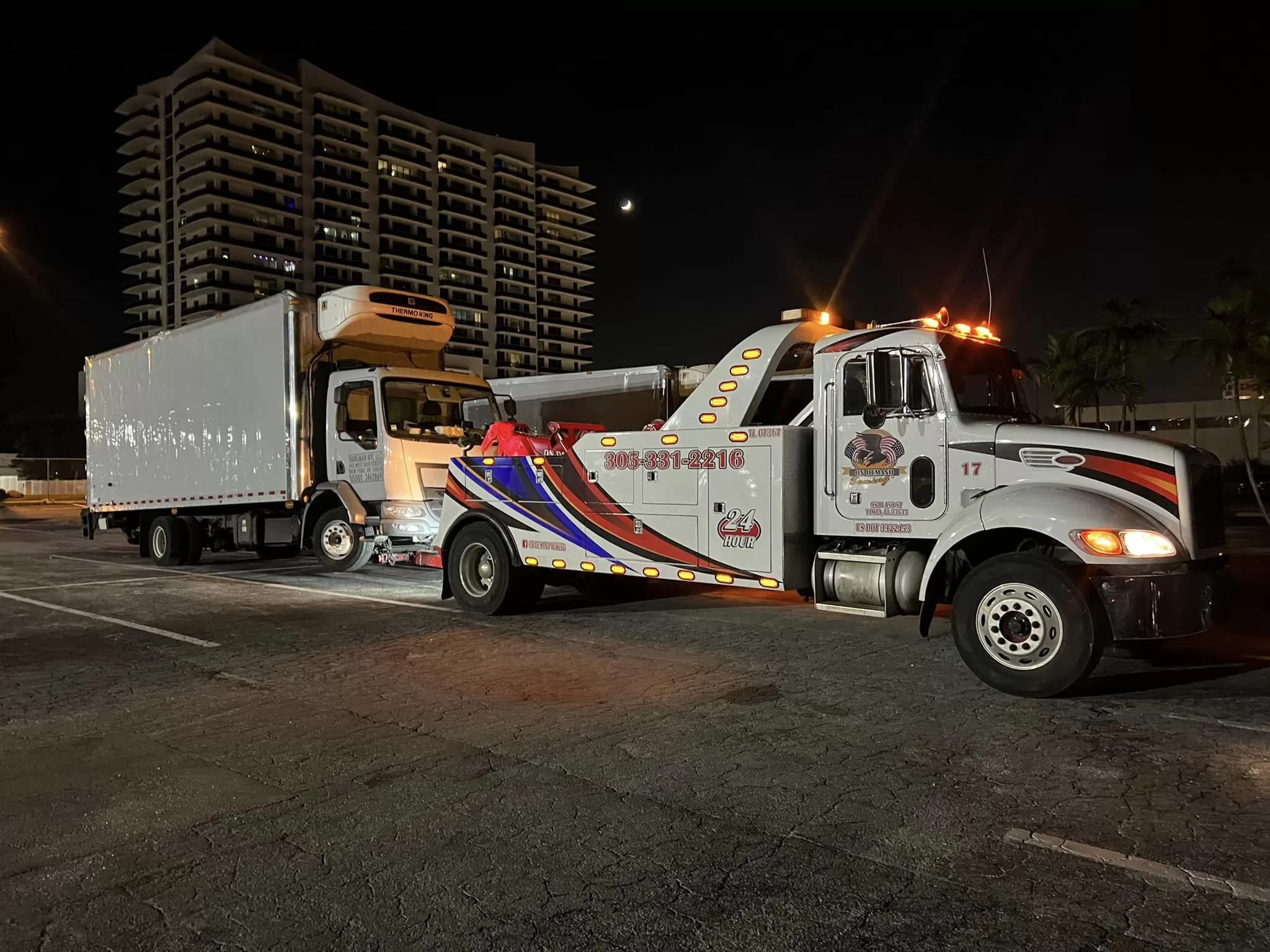 Heavy duty tow truck towing a truck in Downtown Miami Florida