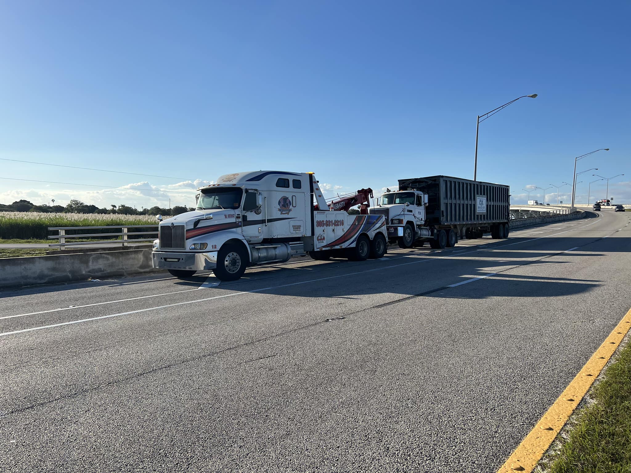 Heavy duty tow truck towing a truck in Okeechobee Miami Florida