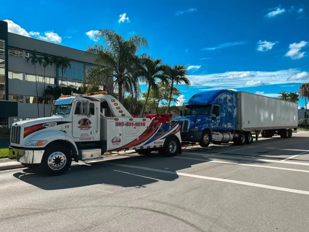 a tow truck towing a truck in miami